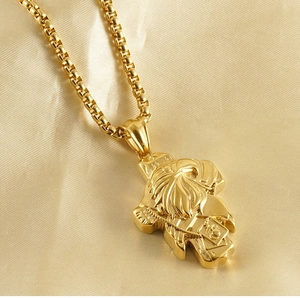 Macro shot of 18K gold plated eagle and cross pendant on satin background