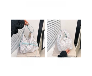 Detail view of floral canvas bucket bags with blue ribbon bows and woven edges