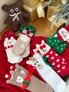 Detailed view of plush coral fleece Christmas socks featuring cute cartoon embroidery designs