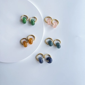 Detailed view of 18k gold plated hoop earrings featuring colorful natural stone beads