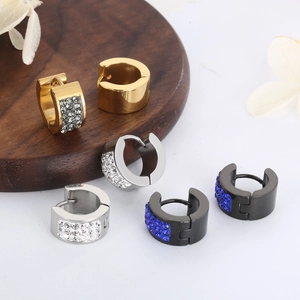 Three pairs of crystal-studded stainless steel hoop earrings in gold, silver, and black