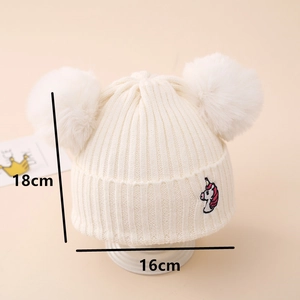 Detailed size view of white unicorn knit hat with two pom-poms measuring 18cm by 16cm