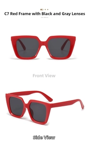 Detail view of bold red square oversized sunglasses with dark gray lenses and glossy finish