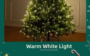 Detail of warm white LED copper wire fairy lights wrapped on a green Christmas tree