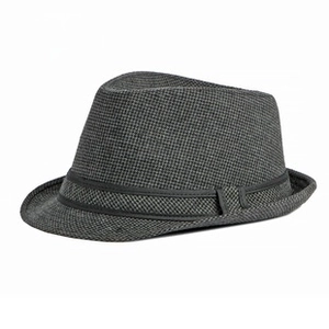 Detailed view of grey wool fedora hat with fine houndstooth texture and black ribbon