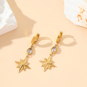 Gold plated titanium earrings featuring star pendants and clear teardrop crystals