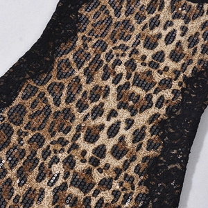 Macro detail of leopard print fabric with gold sequins and black floral lace embroidery