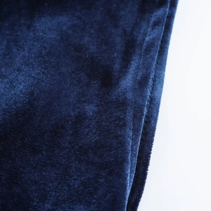 Close-up of deep blue velvet fabric texture and professional stitching on the midi dress