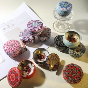 Scented soy wax candles with dried flowers in colorful mandala pattern tin containers