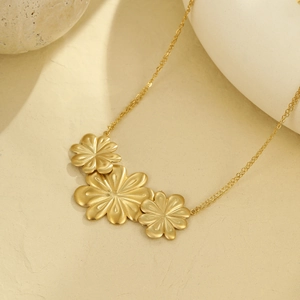 Elegant gold-tone stainless steel necklace featuring brushed triple petal floral charms