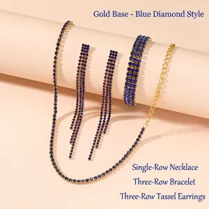 Detail of gold jewelry set with dark blue rhinestones including choker, bracelet and earrings