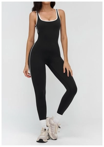 Detailed view of black yoga jumpsuit with white contrast piping and square neckline