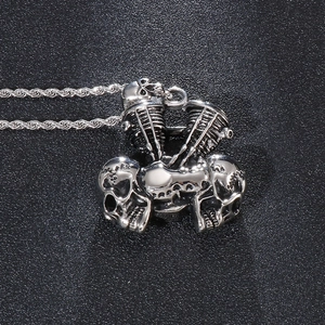 Macro view of silver skull engine pendant on a durable stainless steel rope chain