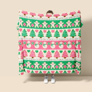 Close-up of flannel Christmas blanket with gingerbread and Season's Greetings prints