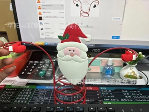 Detailed view of Santa Claus themed wine glass holder stand with festive red metal finish