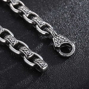 Macro detail of 12mm punk steel chain featuring vintage relief texture and wolf head clasp