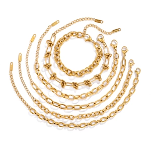 Detail of 7-piece gold stainless steel chain set featuring paperclip and rope link designs