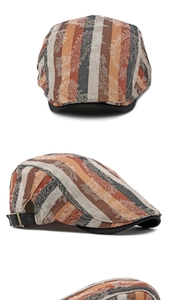 Detail view of paisley and striped cotton flat cap with an adjustable metal buckle strap