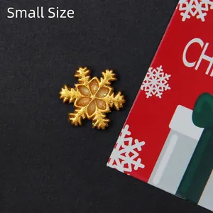 Detailed macro view of a small golden glitter snowflake charm for DIY holiday crafts