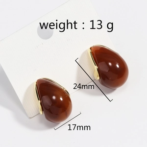 Detailed view of 24mm vintage amber resin U-shape drop earrings with gold metal trim