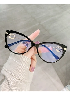 Detail of TR90 cat-eye frame with metal temples and rhinestone accents in hand