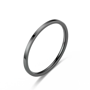 Close-up of a minimalist slim black polished titanium steel ring with smooth finish