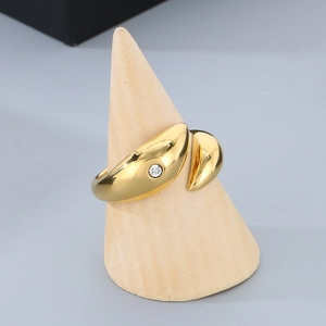Detailed close-up of 18k gold-plated dolphin hip-hop ring with inlaid crystal on a stand