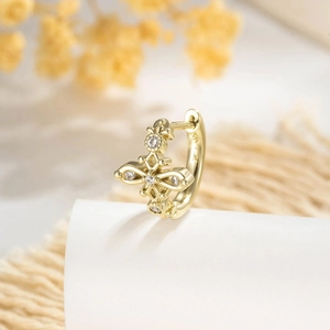 Elegant gold hollow cross hoop earring with sparkling zircons in a vintage French style