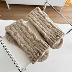 Winter chunky cable knit socks in khaki wool blend displayed on minimalist shelf