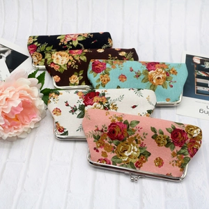 Five assorted floral canvas clutch bags with vintage metal clasps in various colors