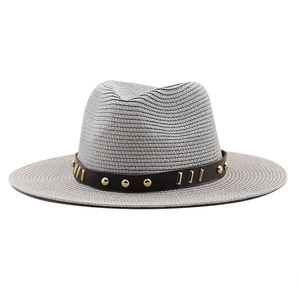 Close-up of grey fedora straw hat with brown leather band and gold metal hardware
