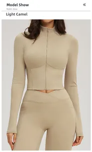 Front view of women's light camel yoga jacket with zip collar and matching leggings