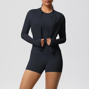 Detail of black 3-piece fitness set with zip jacket, tank top, and high-waist shorts