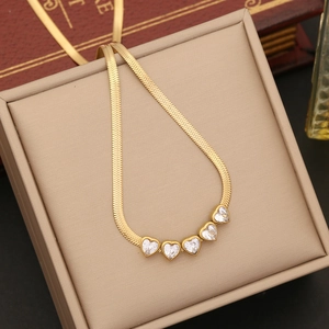 Detail of gold snake chain necklace featuring five heart-shaped zircon stones in a gift box