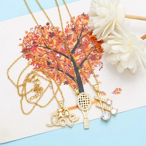 Detailed view of three gold-plated necklaces with love, tennis, and zircon pendants