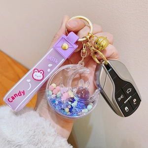 Detailed view of purple moon rabbit keychain with liquid sand charm and silicone strap