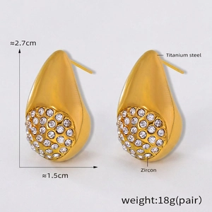 Macro detail of teardrop pave zircon earrings with 18K PVD gold plating on titanium steel