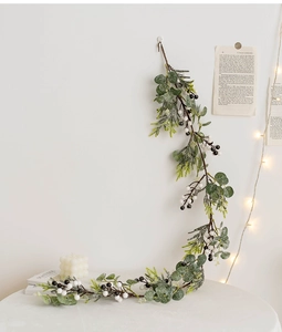 Close-up of Christmas eucalyptus rattan with pine needles and berries for home decor