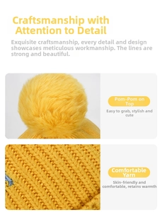 Close-up of ginger yellow ribbed knit hat featuring a soft faux fur pompom and thick texture