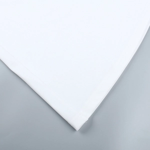 Detailed close-up of fine double-needle stitching on white pleated dress hemline