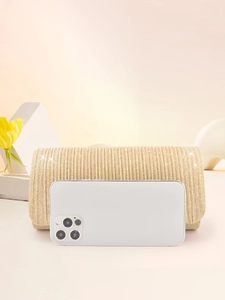 Detailed size comparison of a gold pleated glitter evening clutch next to a smartphone