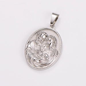 Close-up of vintage silver oval pendant featuring detailed family of three relief carving