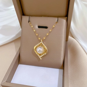 Detail of luxury rhinestone necklace with pearl pendant in a premium jewelry gift box