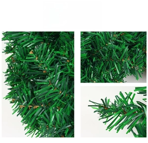 Macro detail showing realistic PVC pine needle texture and brown wire core of Christmas wreath