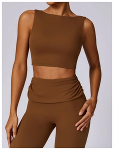 Detail view of high-waist ruched yoga leggings and racerback crop top in dark brown