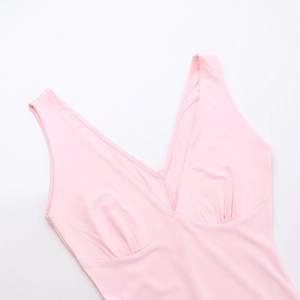 Detail of pink deep V-neck ruffled dress showing the pleated bust and knit fabric texture