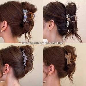Detailed views of cute cartoon claw clips featuring cat, dog and bear shapes for hair