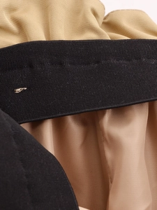 Vue détaillée de la texture du tissu kaki et de la taille élastique noire avec couture fine