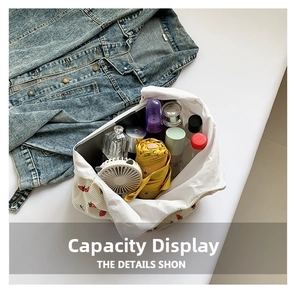 Detail view of the spacious inner compartment of the corduroy tote bag with strawberry print
