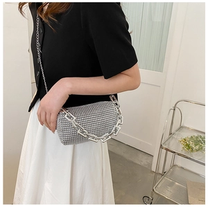 Close-up of sparkling silver rhinestone evening bag with chunky chain handle and shoulder strap